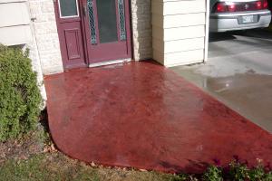 Red stamped decorative concrete front door driveway