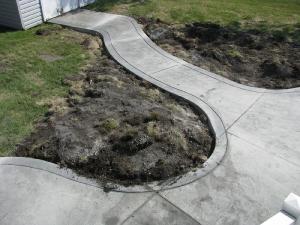 Stamped concrete sidewalk backyard