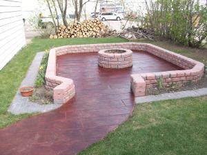 Wood plank colored stamped concrete firepit